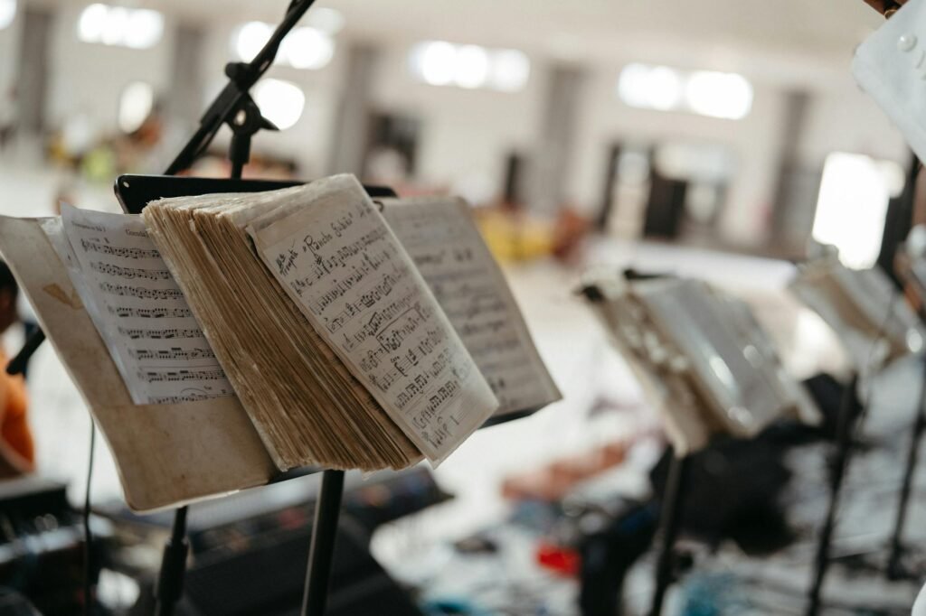 Marked-up sheet music with a metronome and pencil on a music stand.