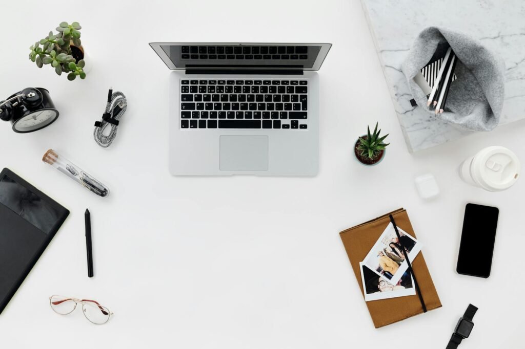 A tidy desk set up for focused practice with a notebook, laptop, and timer