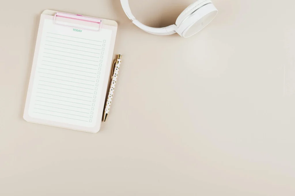 An organized practice desk with a notebook, tuner, and printed plan