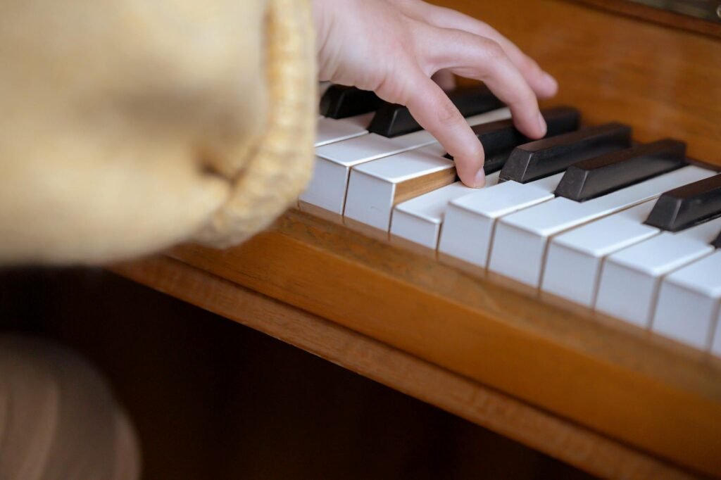 Hands resting calmly on piano keys before the first note