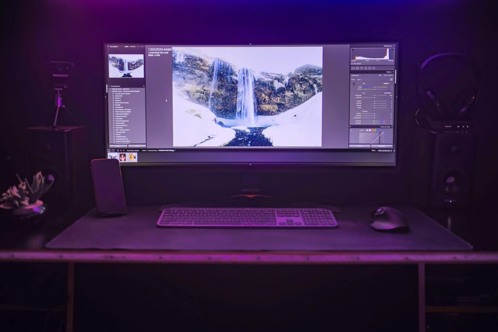 A simple studio workspace with a keyboard and speakers set up for focused editing.