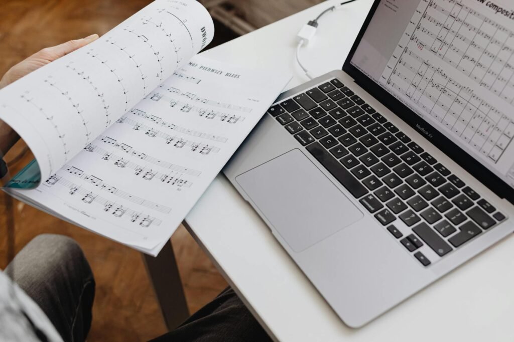 A practice notebook with tempo notes and a metronome on an organized desk