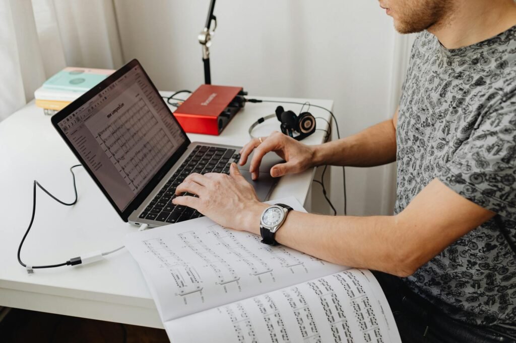 A tidy practice workspace with a notebook, timer, and marked sheet music