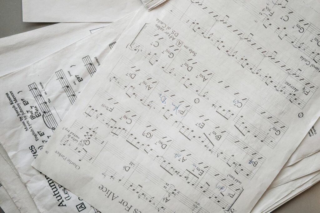 A practice journal with tempo notes and checkmarks beside sheet music