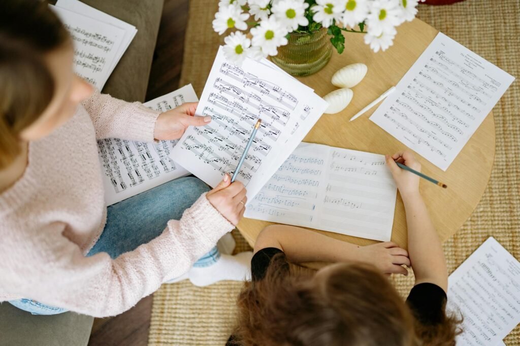 A close-up of a practice calendar and sheet music marked with pencil notes