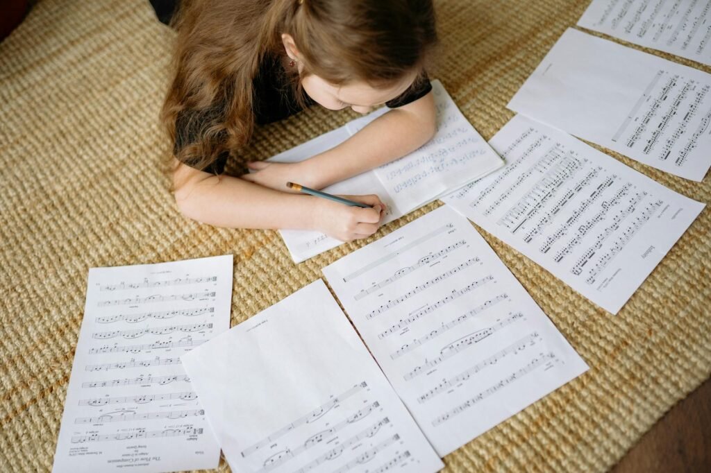 Marked-up sheet music beside a metronome and notebook during a practice session