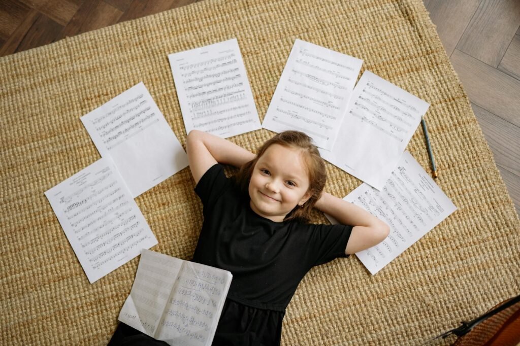 A musician studying marked sheet music with a pencil and timer at a desk