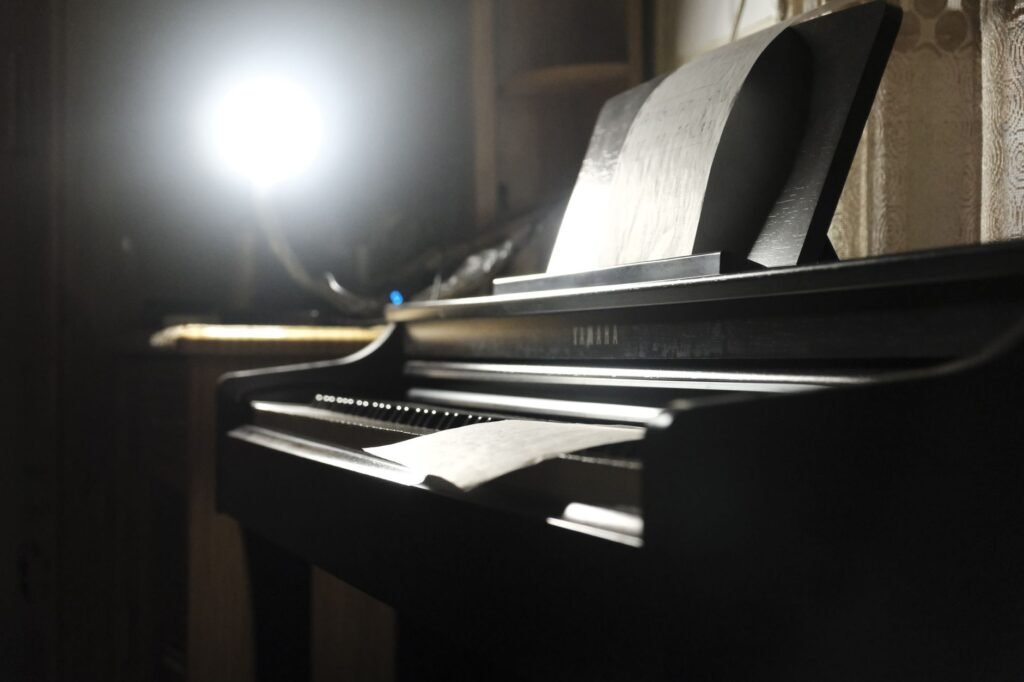 A digital metronome next to marked-up sheet music on a music stand