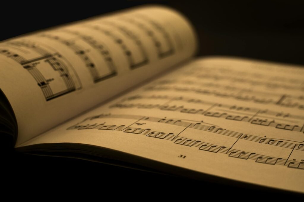 Hands tapping a steady beat next to a page of printed music