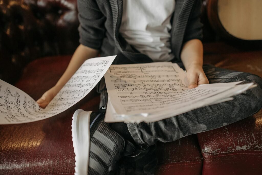 Musician practicing from a score with a notebook open beside the stand