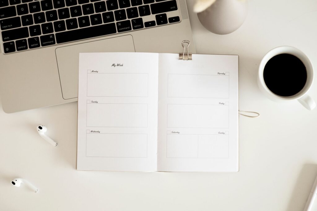 A weekly planner and notebook with a short practice checklist on a kitchen table.